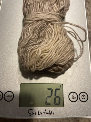 partial skein of yarn on a scale